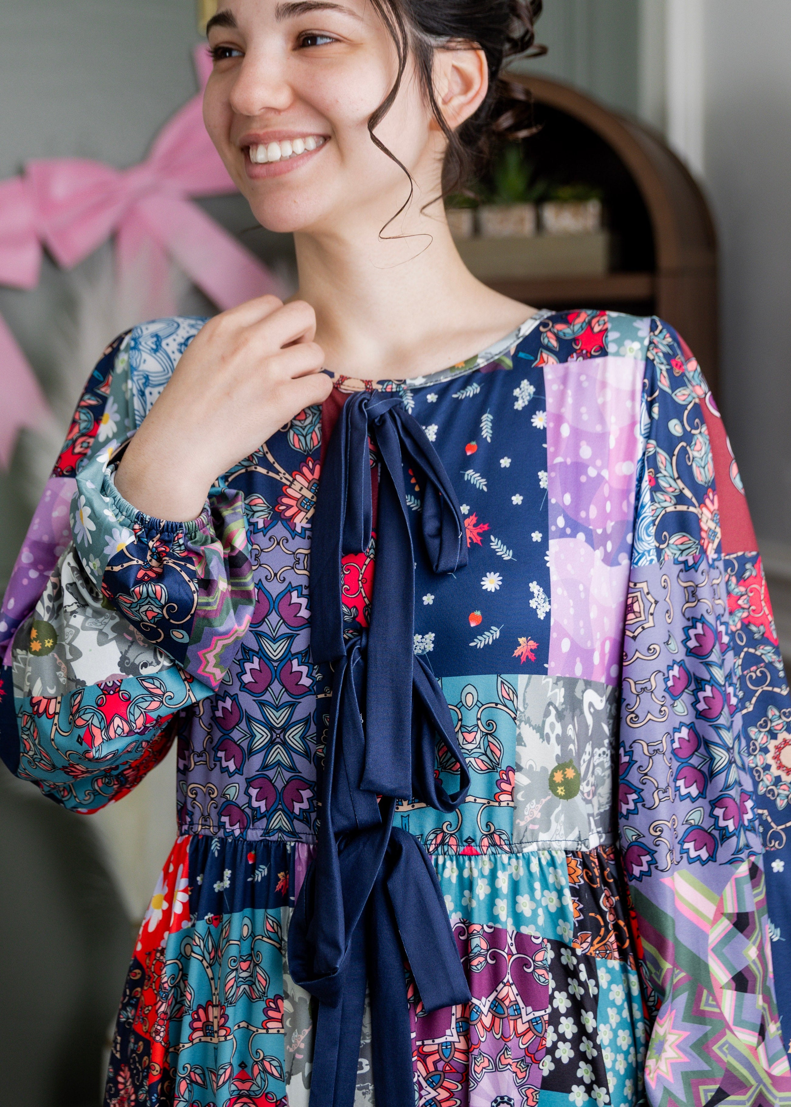 Model wearing the Nuggles® Addison Dress in Stitch & Sparkle