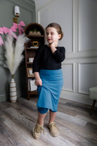 Model wearing Nuggles® Girls' All-Sport Skirt in Turquoise