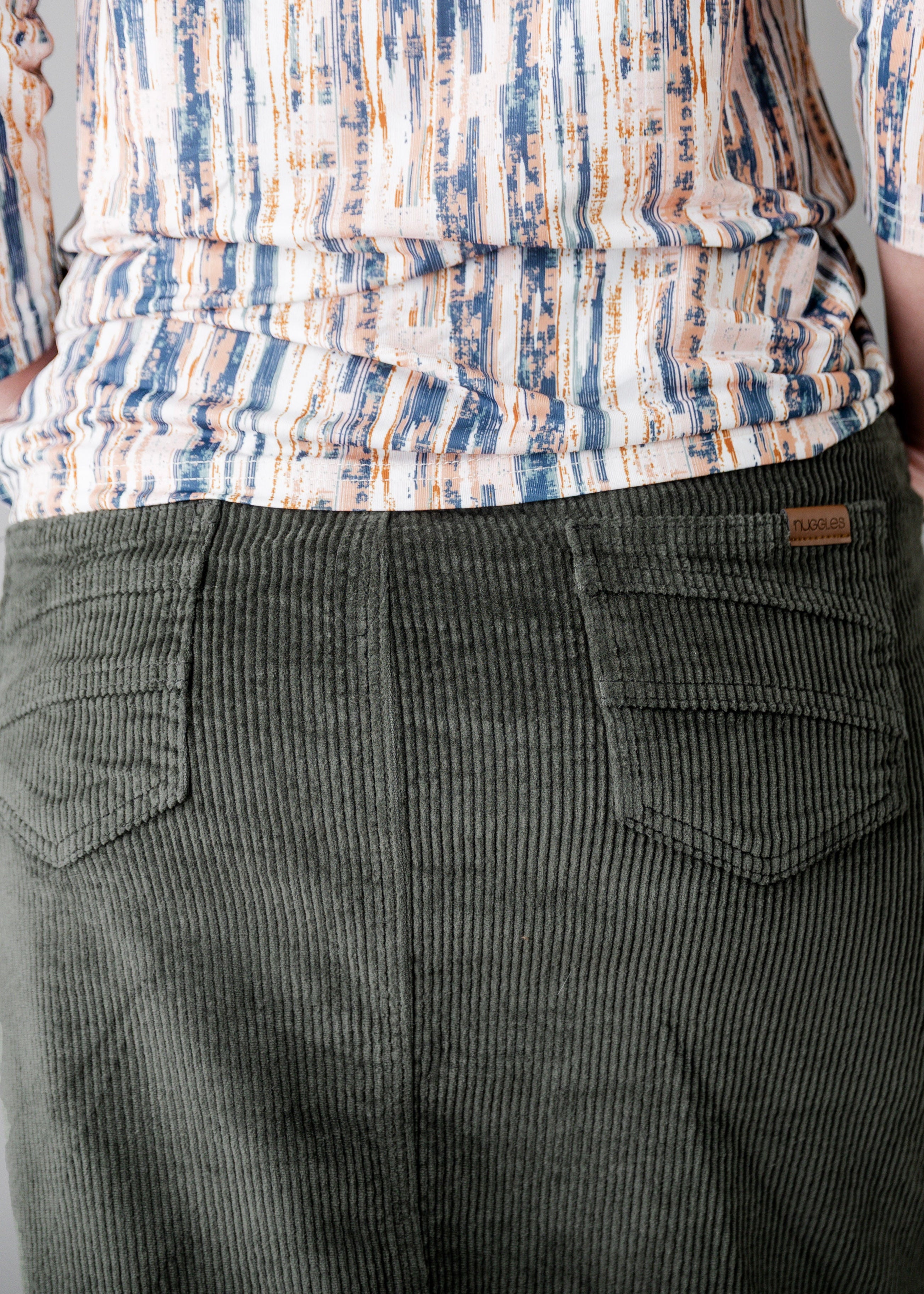 Model wearing Nuggles® 27-inch corduroy skirt