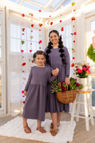 Model wearing the Nuggles® Girls' Farah Dress in Purple
