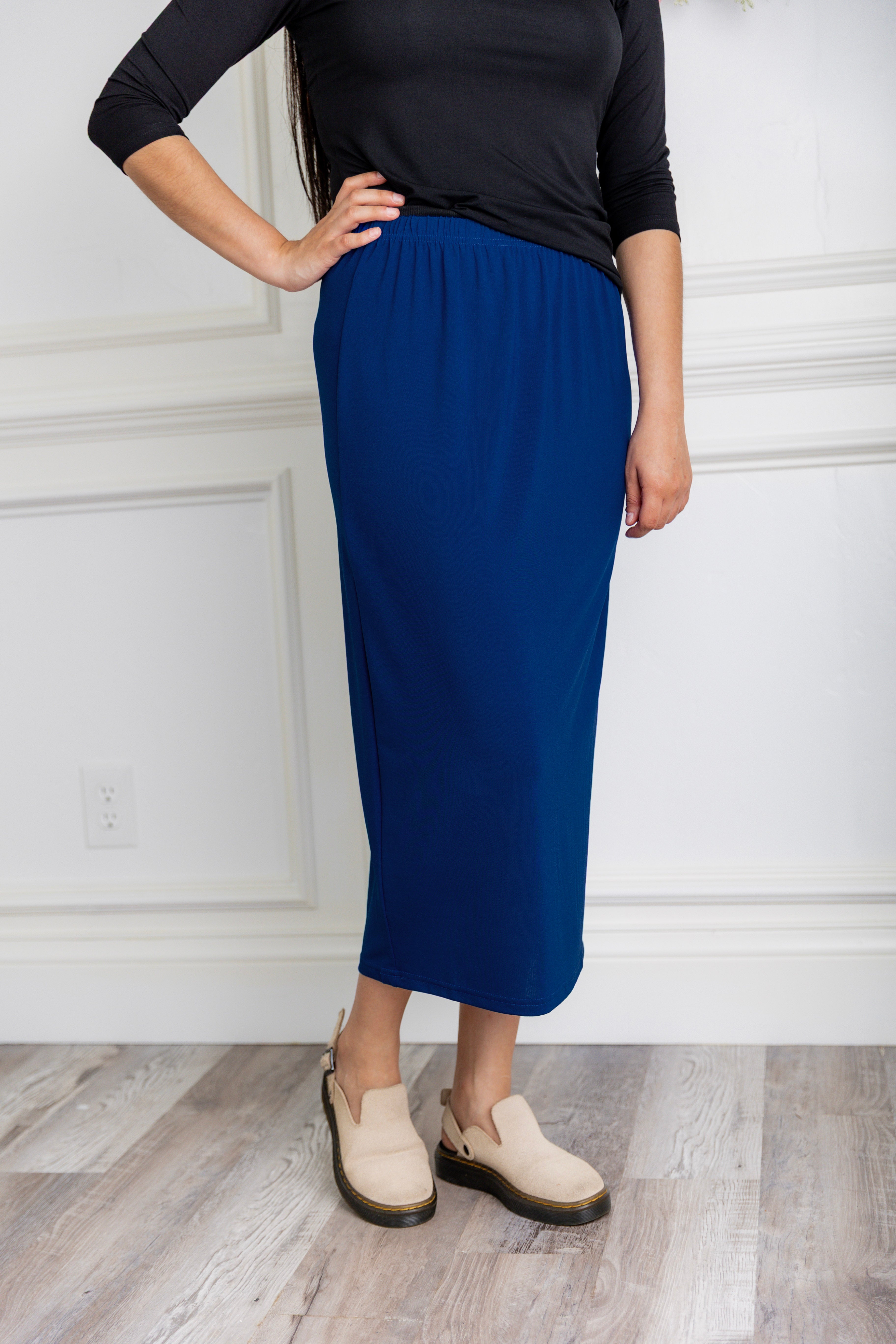 Model wearing a 31-inch classic lightweight midi skirt with an elastic waistband, styled modestly for everyday or church wear.