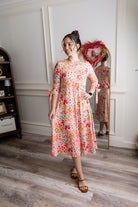 Model wearing the Nuggles® Hazel Dress in Confetti Garden Bloom floral print modest boutique dress