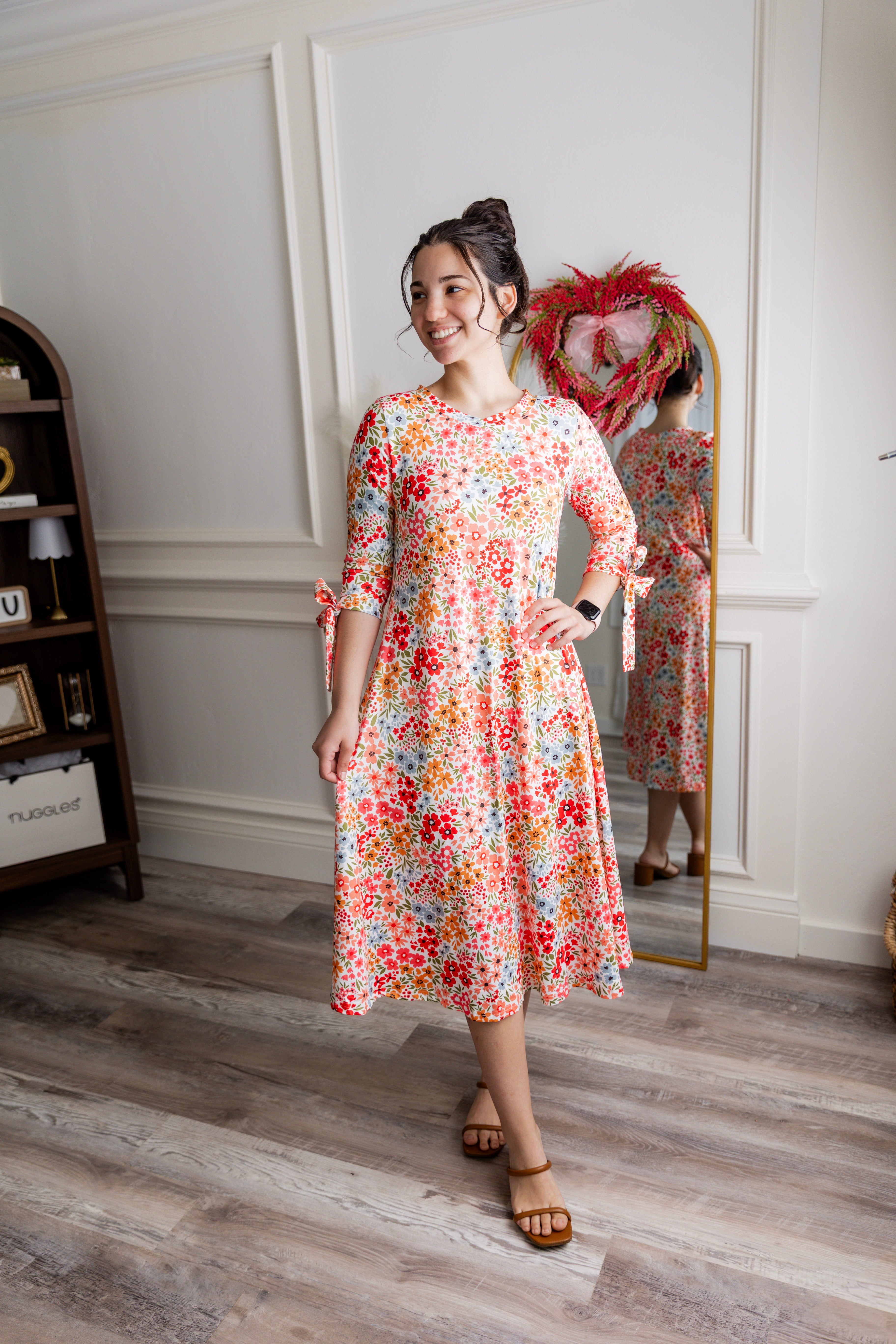 Model wearing the Nuggles® Hazel Dress in Confetti Garden Bloom floral print modest boutique dress