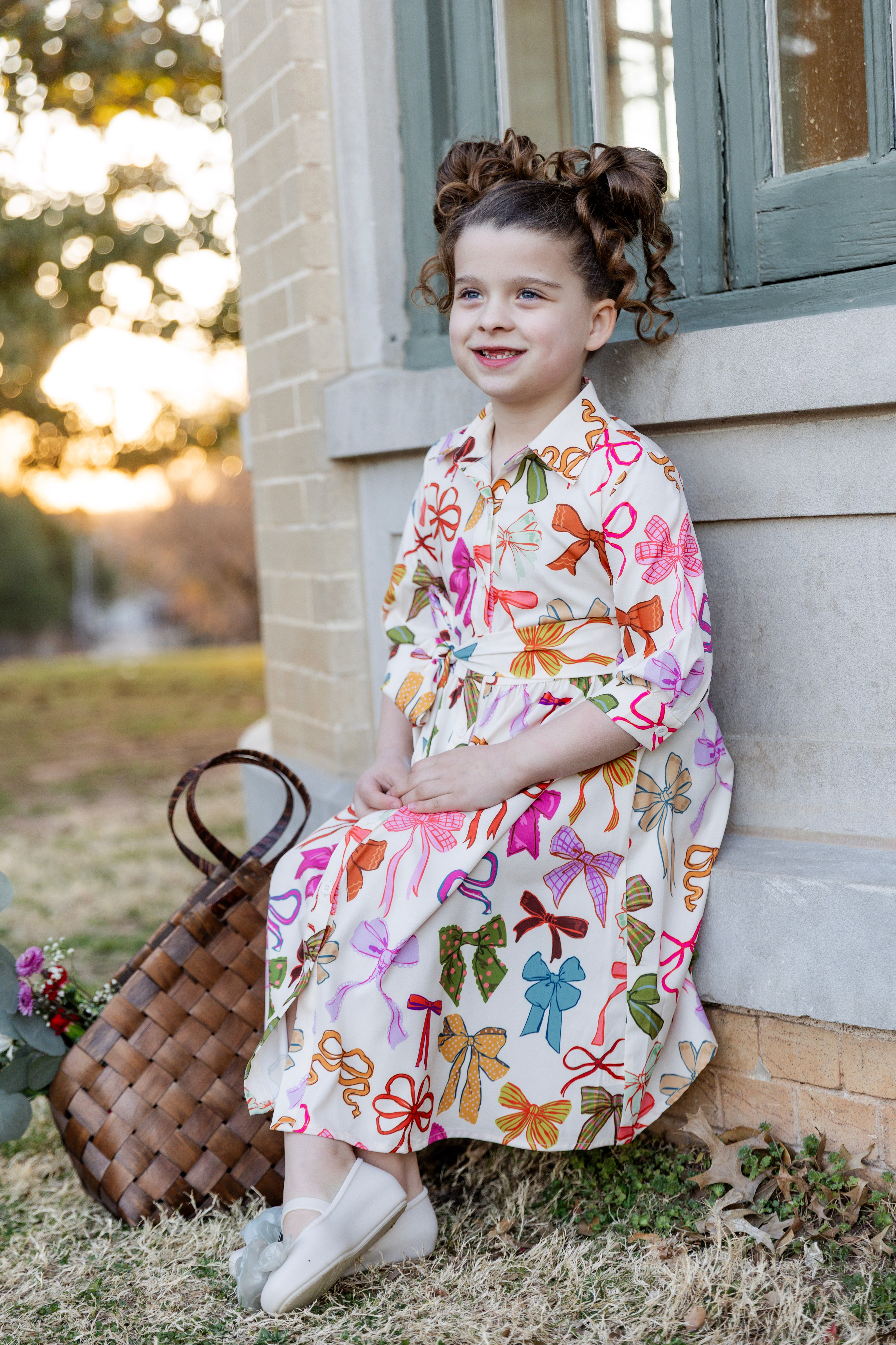 Model wearing the Nuggles® Girls' Rachel Dress in Bow Garden