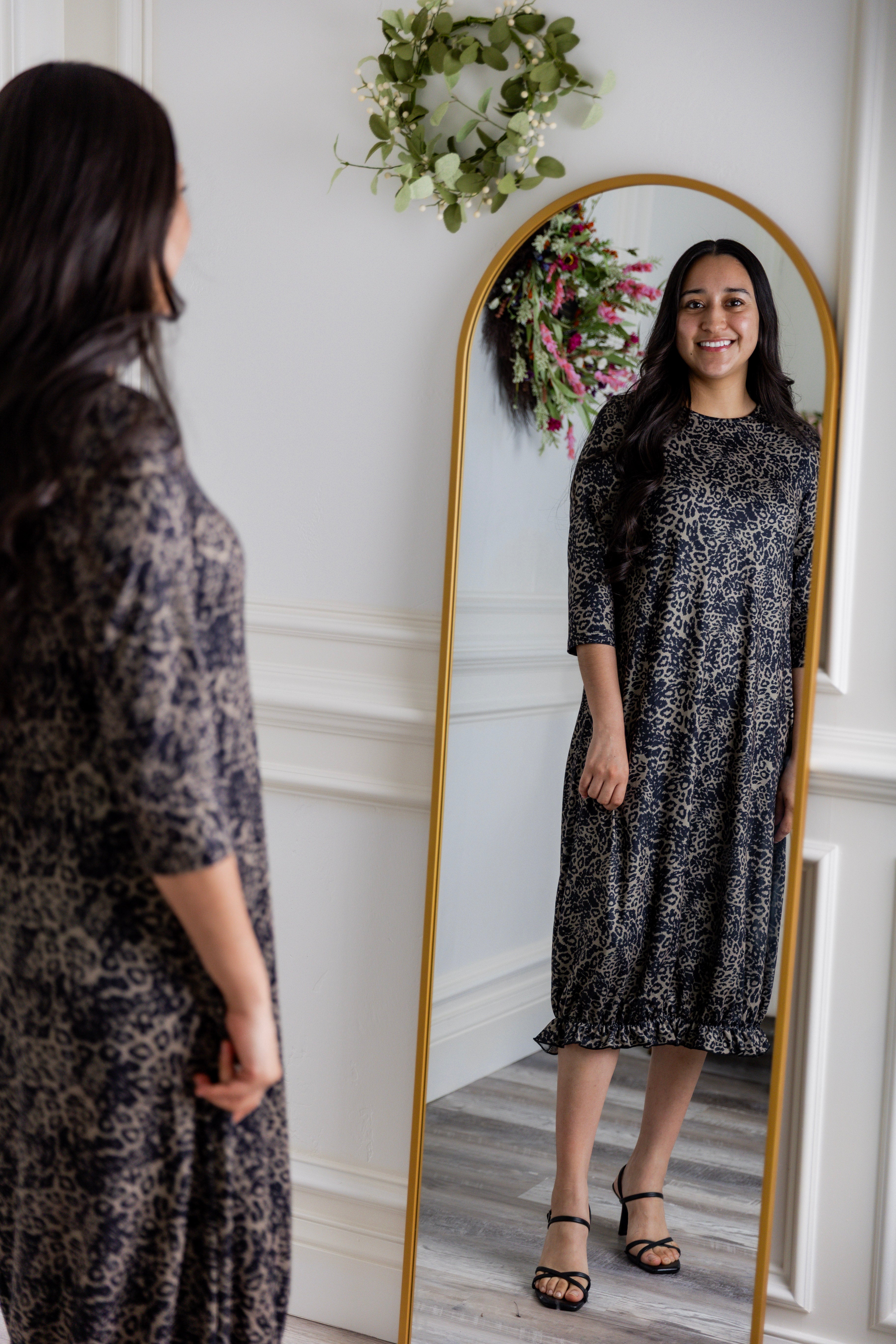 Model wearing our Nuggles® modest Bristol midi dress with 3/4 sleeves and elastic ruffle hem in various prints.