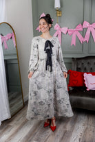 Model wearing the Nuggles® Addison Dress in Whispering Headlines