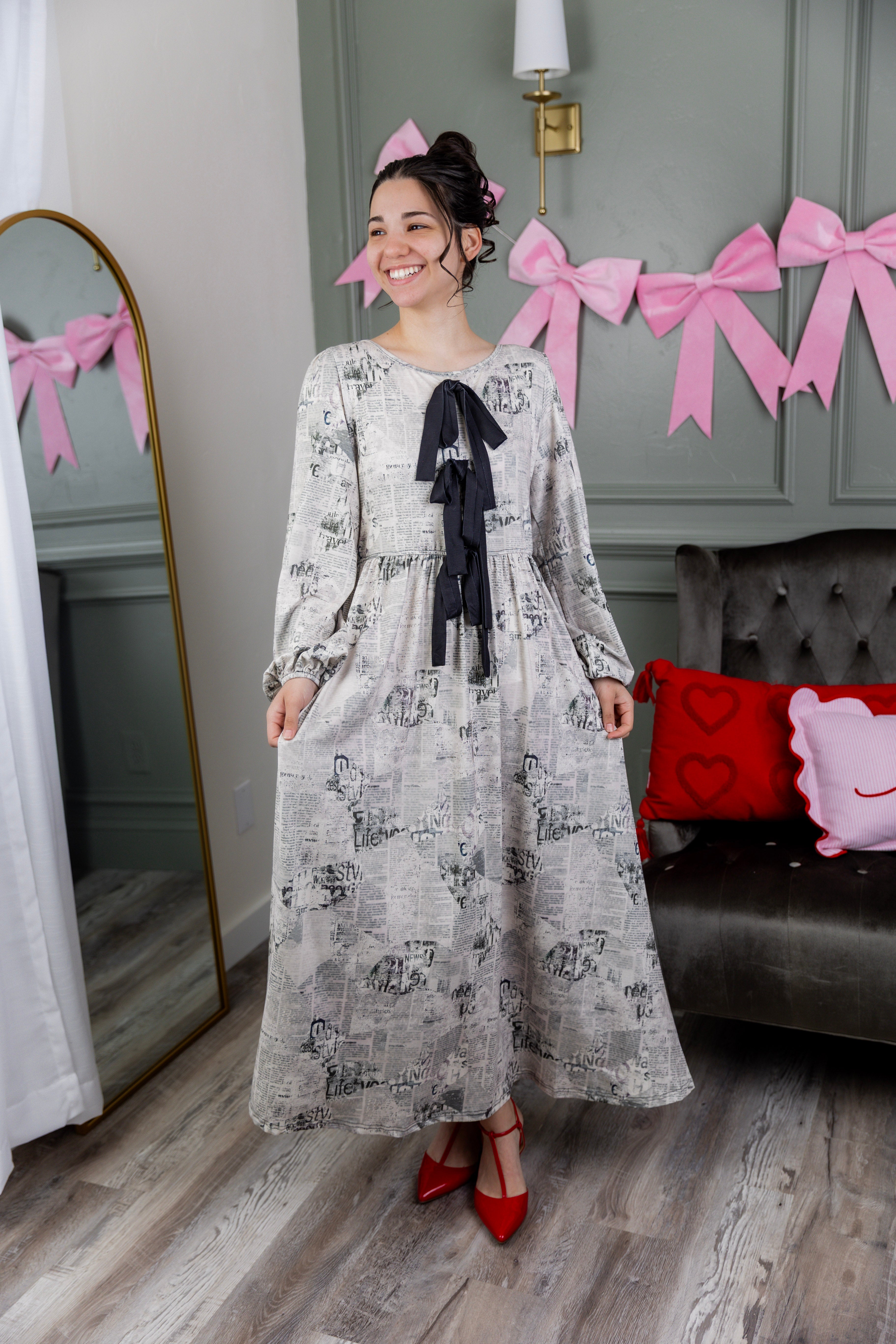 Model wearing the Nuggles® Addison Dress in Whispering Headlines