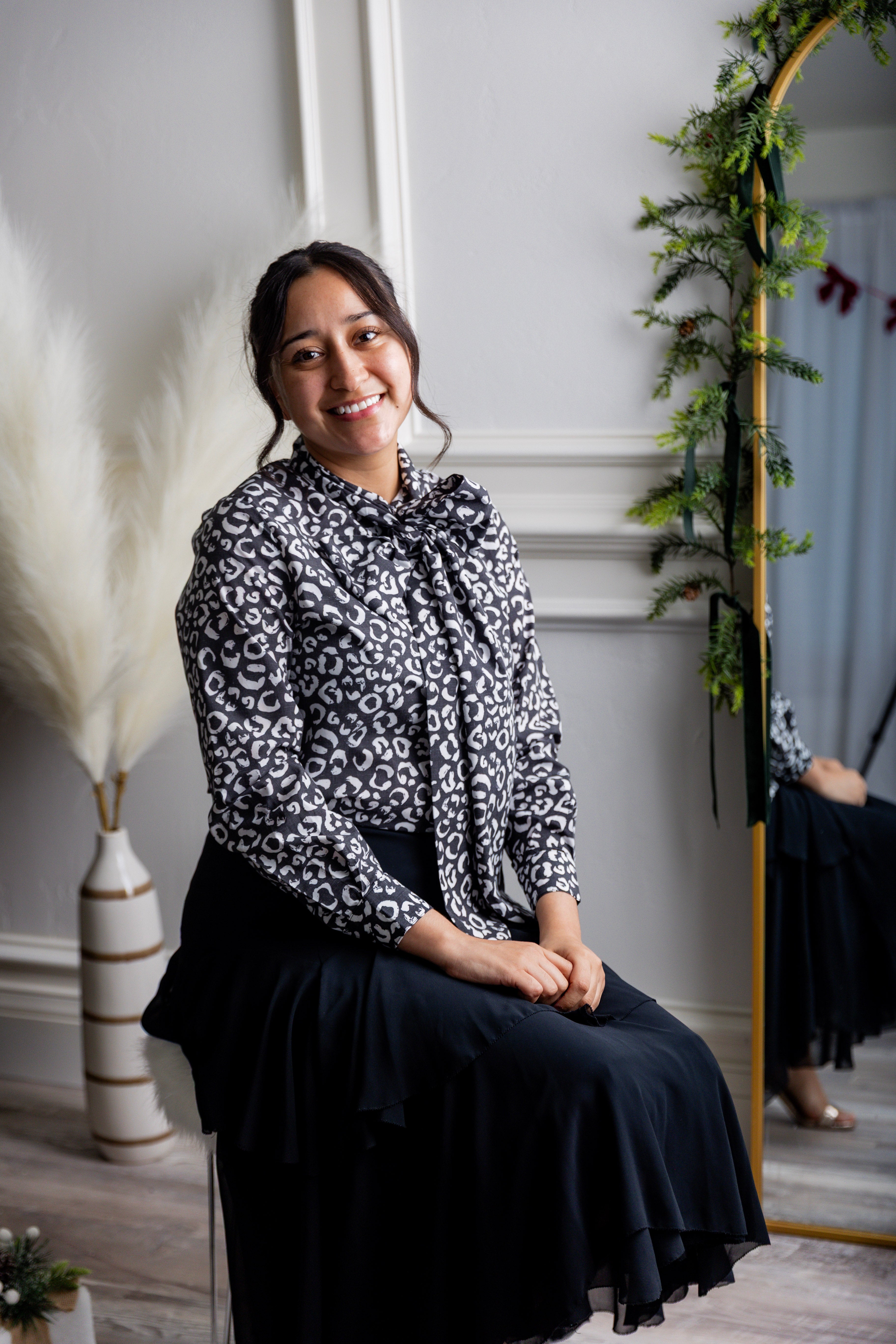 Model wearing Nuggles® Felicity top with large bow tie neckline, modest women's blouse.