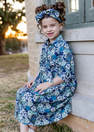 Model wearing the Nuggles® Girls' Rachel Dress in Storm Brush