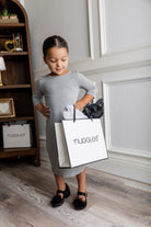 Model wearing our Nuggles® girls midi layering dress