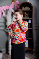 Model wearing Nuggles® Girls' Mesh Tee in Confetti Bloom