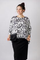 Model wearing the Nuggles® Keegan Top in  Midnight Rose print modest boutique top