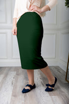 Modest midi skirt in soft knit fabric with a tapered hem and stretch waistband, shown in a classic neutral. A Nuggles favorite in 27", 31", and 34" lengths.