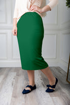 Modest midi skirt in soft knit fabric with a tapered hem and stretch waistband, shown in a classic neutral. A Nuggles favorite in 27", 31", and 34" lengths.