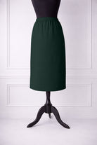 Green skirt on a mannequin against a white wall