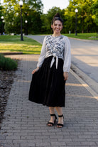 modest long sleeve top with a tie knot and contrasting knit fabrics