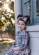 Model wearing the Nuggles® Girls' Rachel Dress in Sand Plaid