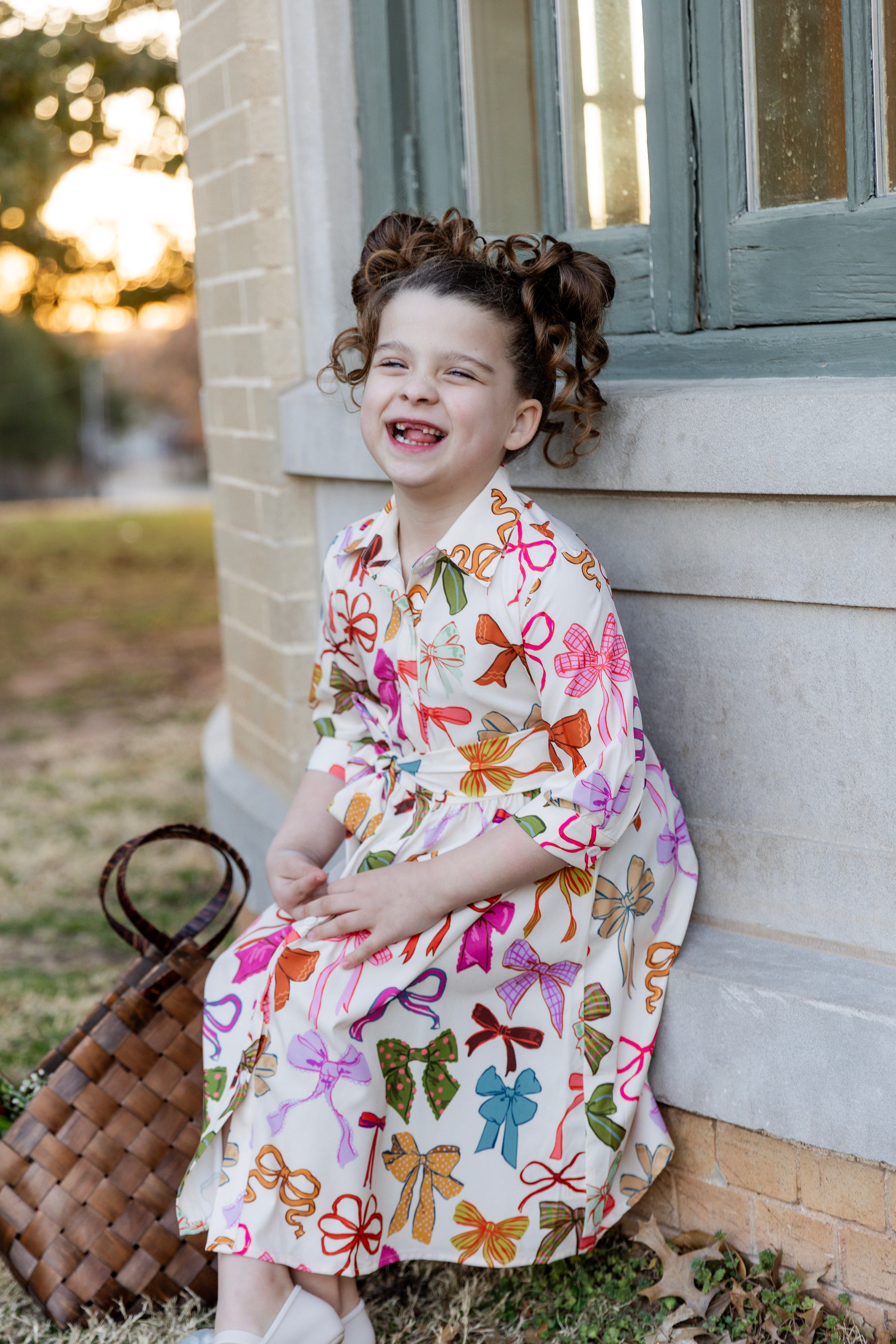 Model wearing the Nuggles® Girls' Rachel Dress in Bow Garden