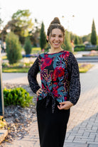 modest long sleeve top with a tie knot and contrasting knit fabrics