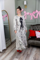 Model wearing the Nuggles® Addison Dress in Whispering Headlines