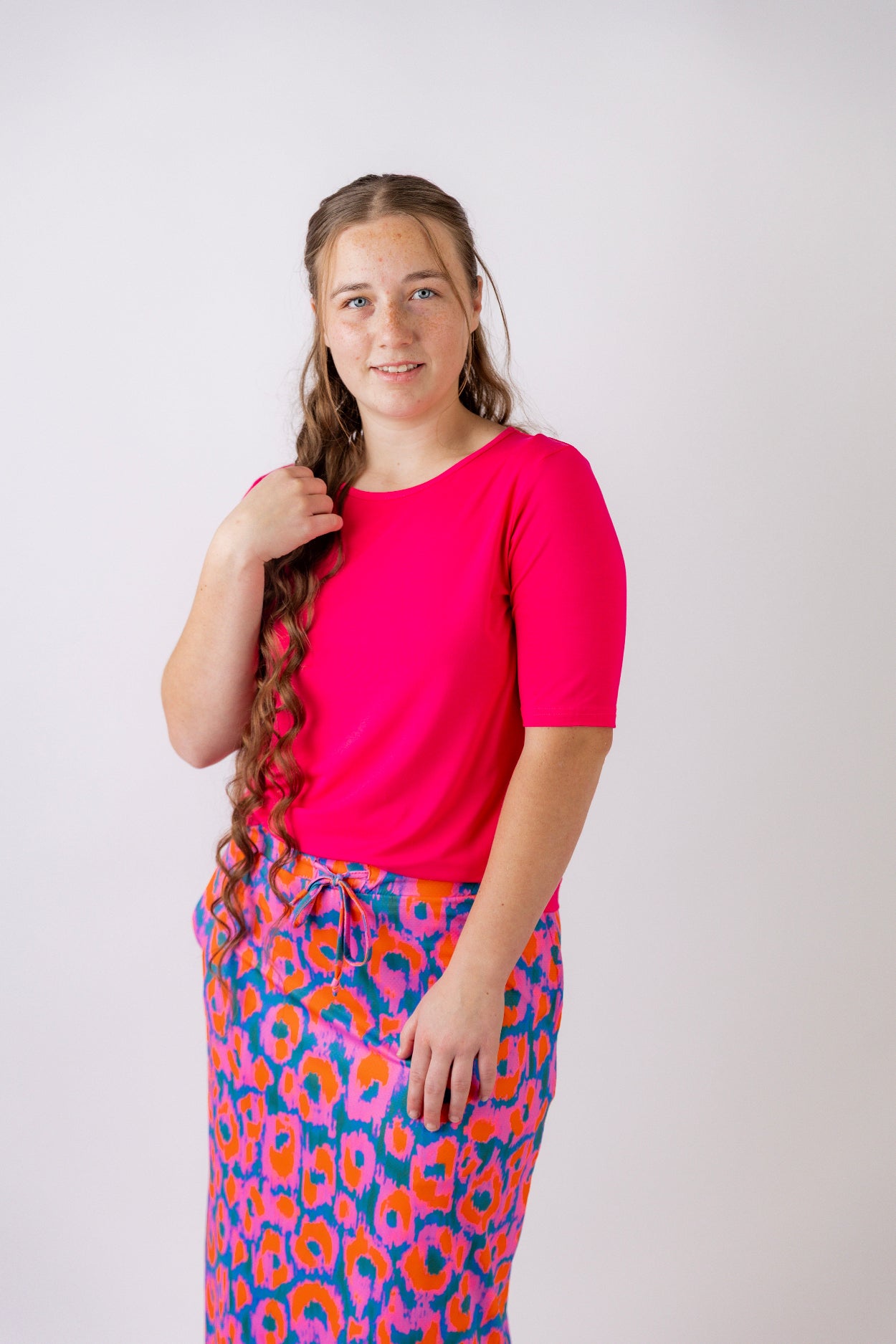 Model wearing the Nuggles® Essential Half Sleeve Tee in Hot Pink