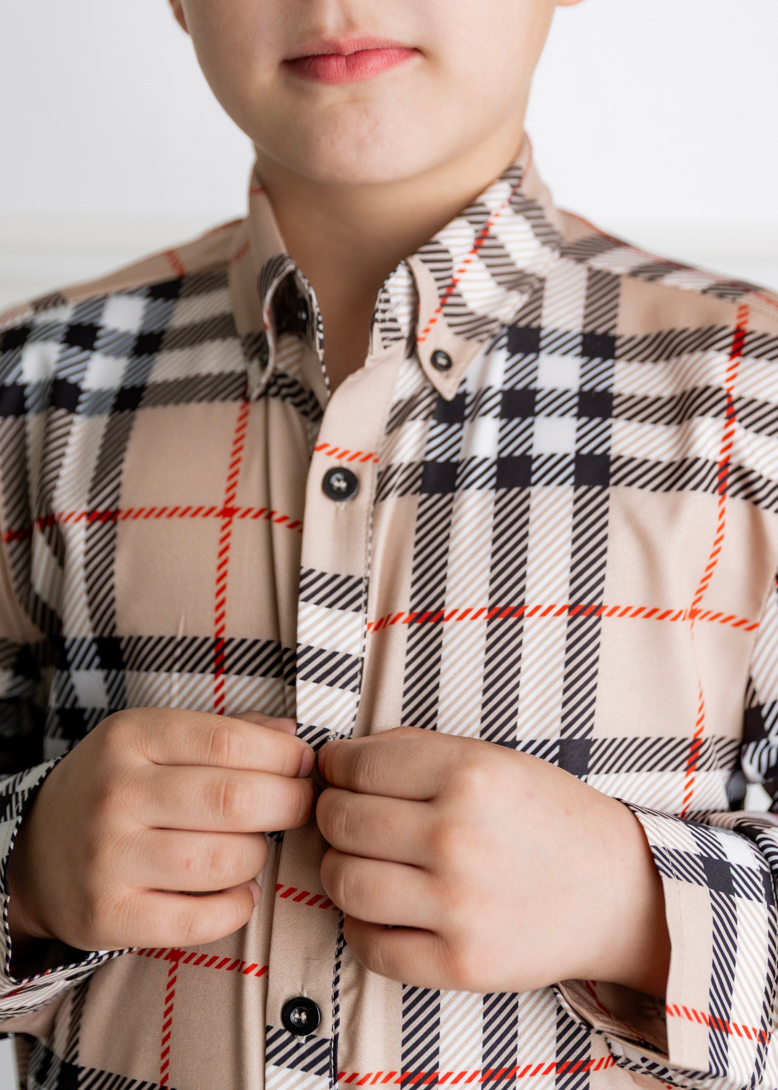 Model wearing Nuggles® Boys' Button Down Shirt Sand Plaid