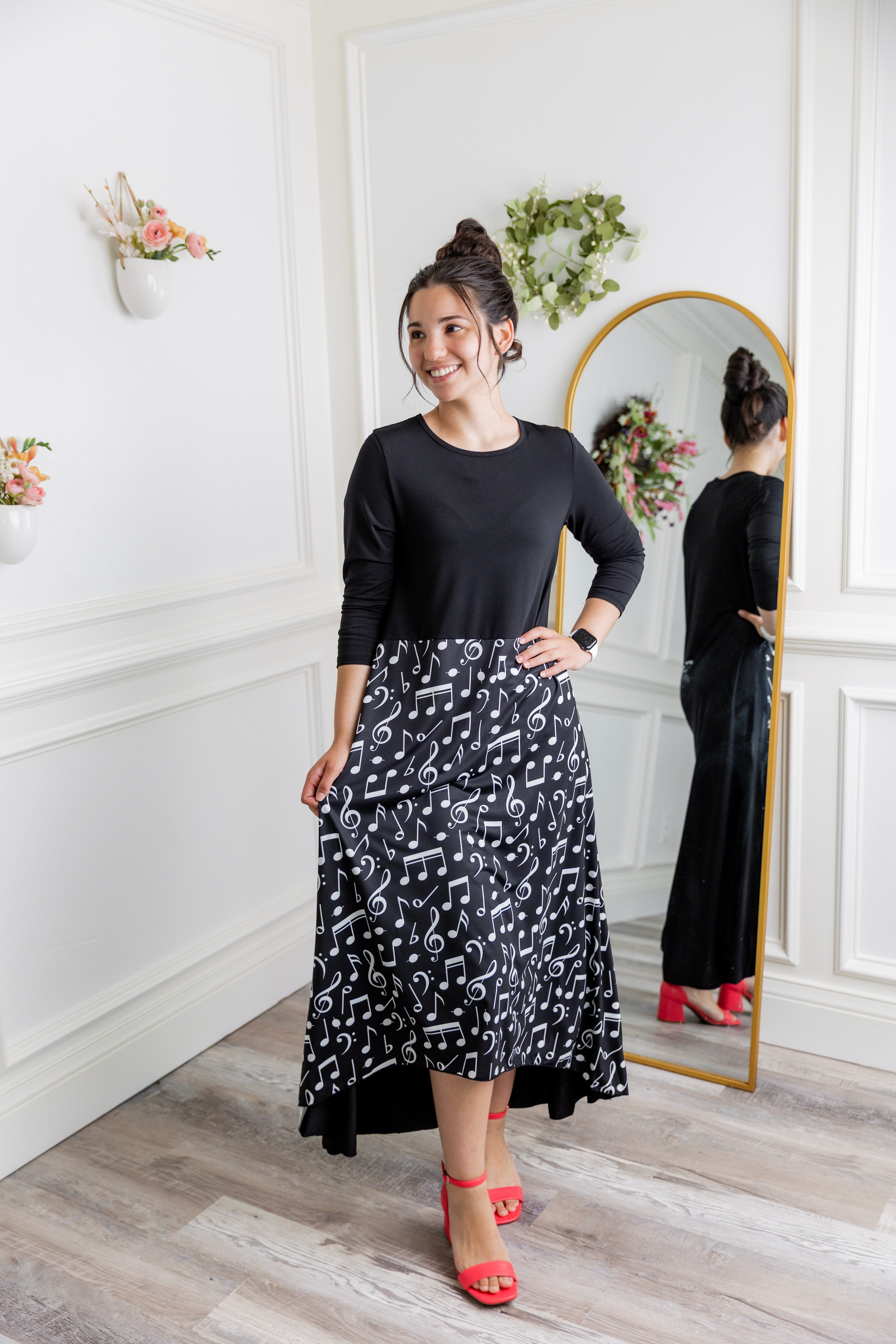 Model modeling Nuggles® Charay Dress with ¾ sleeves and high-low hem. Modest and stylish A-line dress with flattering fit.