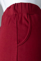 Model wearing Nuggles® 31" Pocket Classic Skirt in Dark Brick