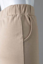 Model wearing Nuggles® 31" Pocket Classic Skirt in Khaki