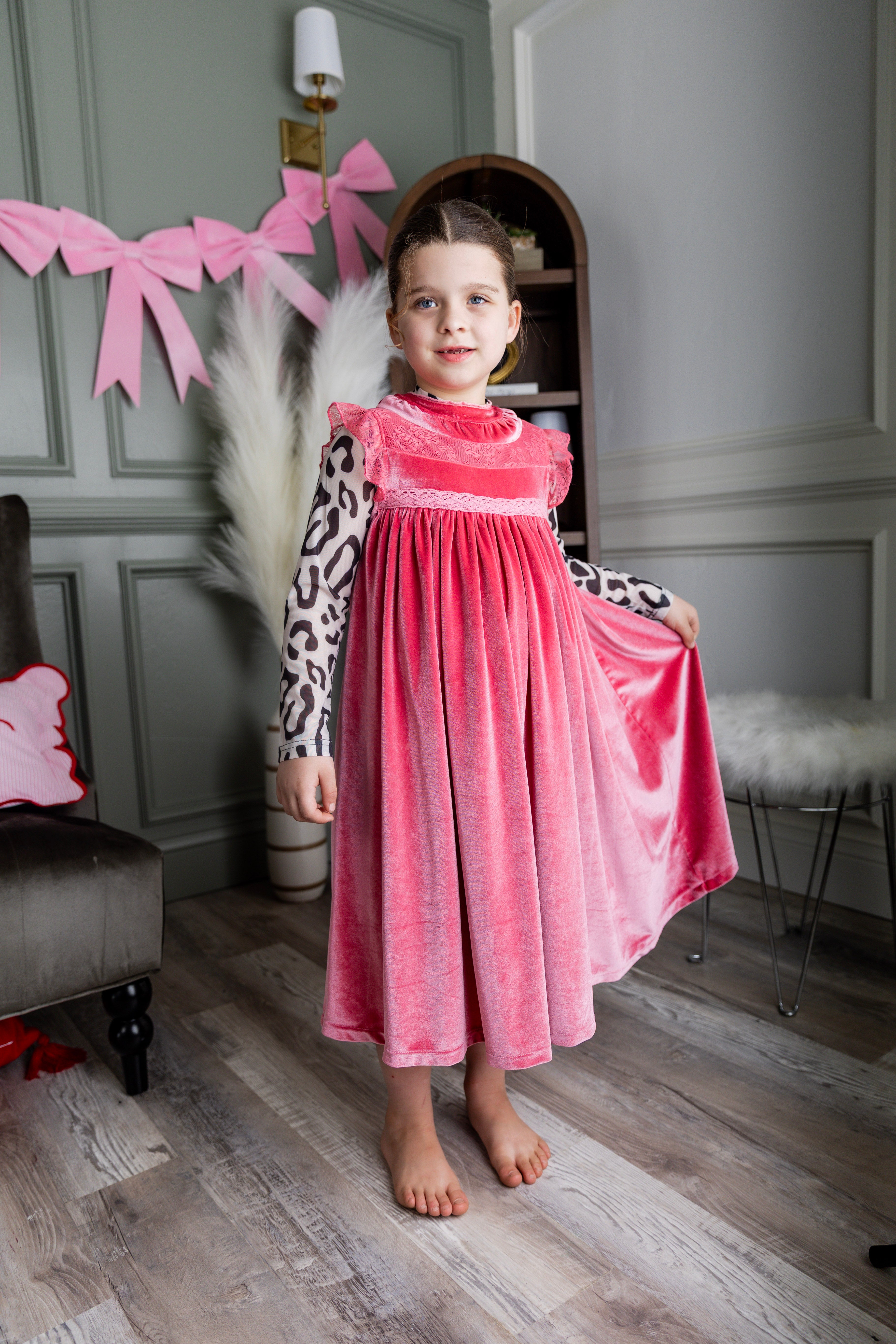 Model wearing Nuggles® Girls' Mesh Tee in Snow Leopard