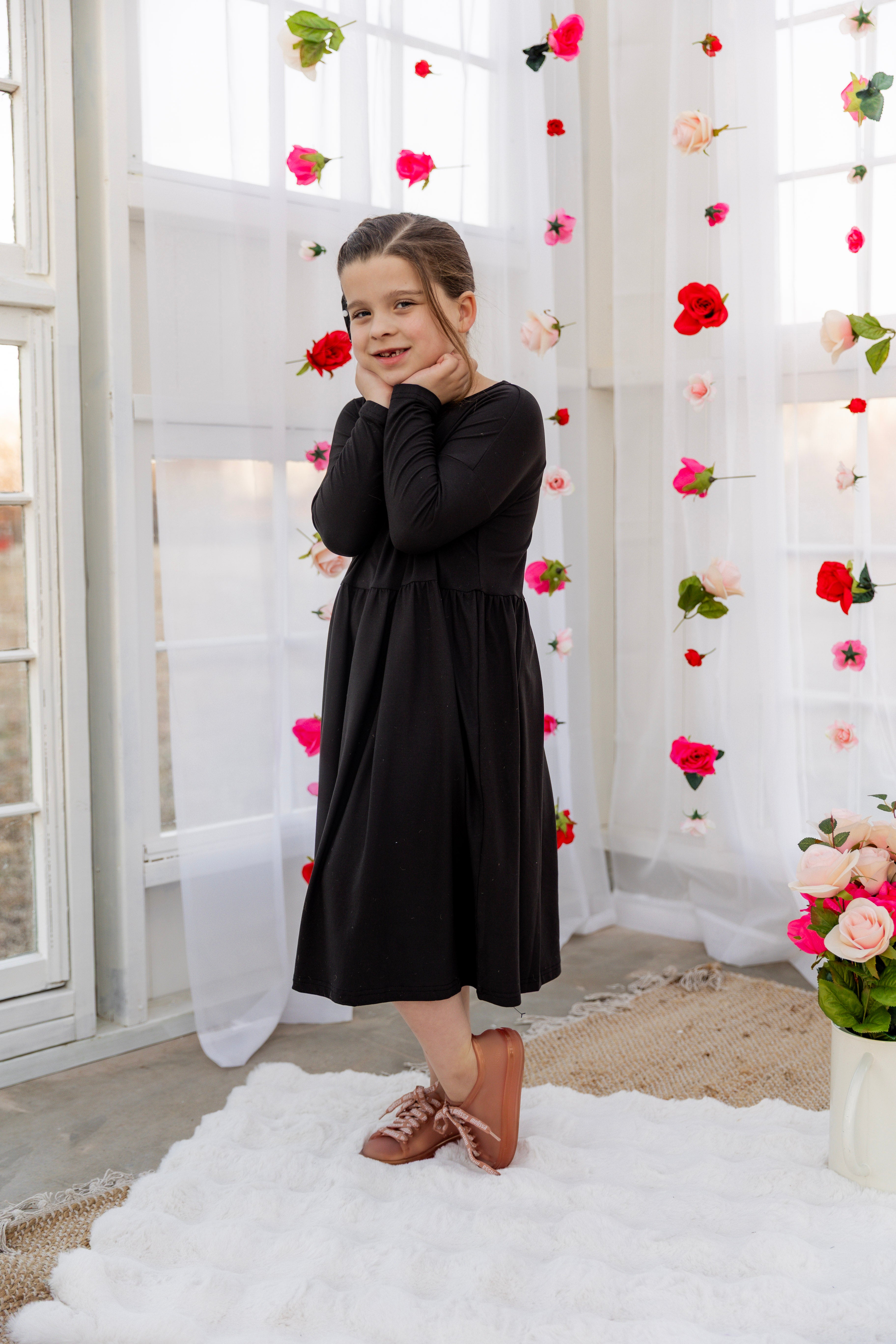 Model wearing the Nuggles® Girls' Farah Dress in Black