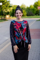modest long sleeve top with a tie knot and contrasting knit fabrics