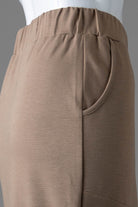 Model wearing Nuggles® 34" Pocket Classic Skirt in Taupe