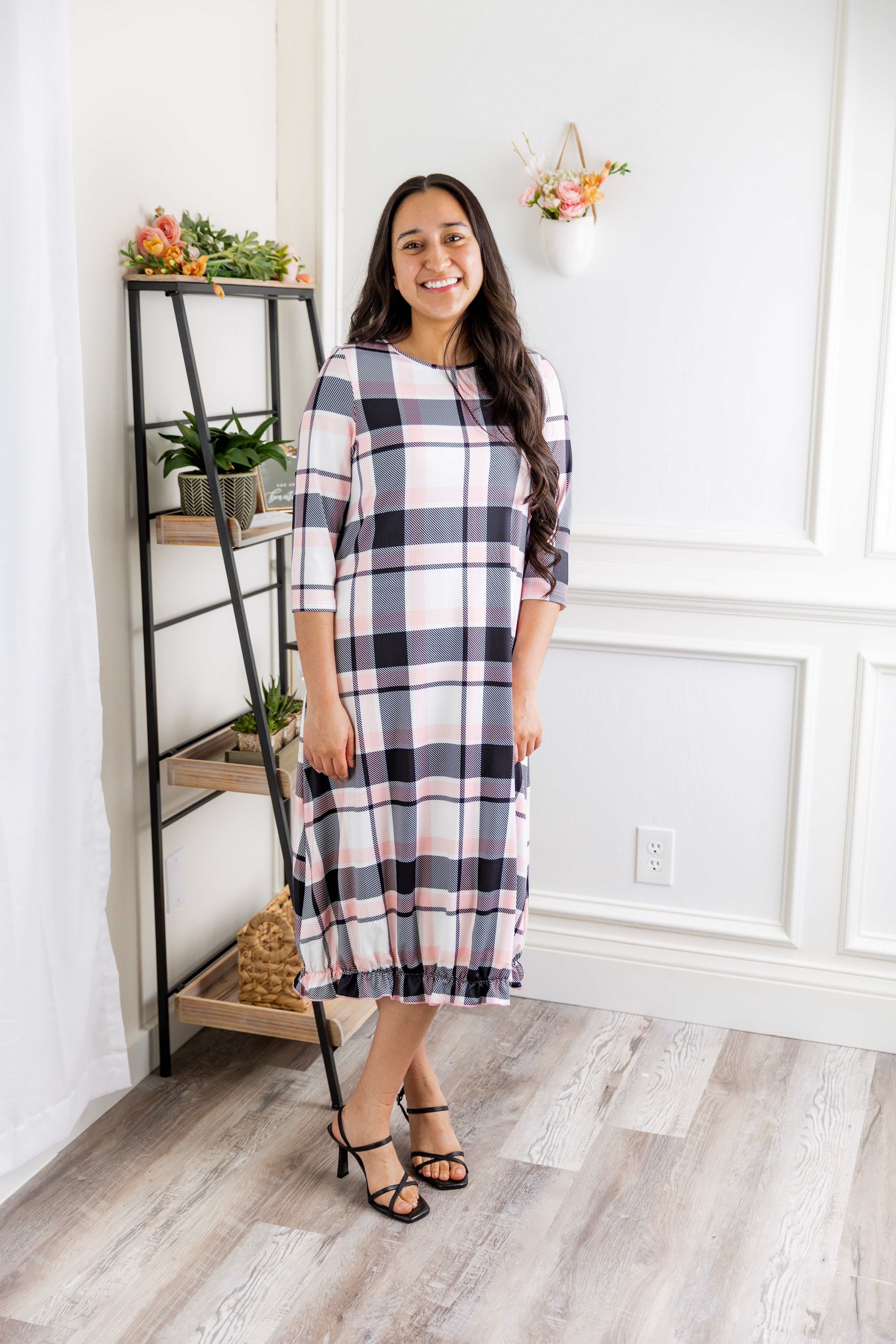 Model wearing our Nuggles® modest Bristol midi dress with 3/4 sleeves and elastic ruffle hem in various prints.