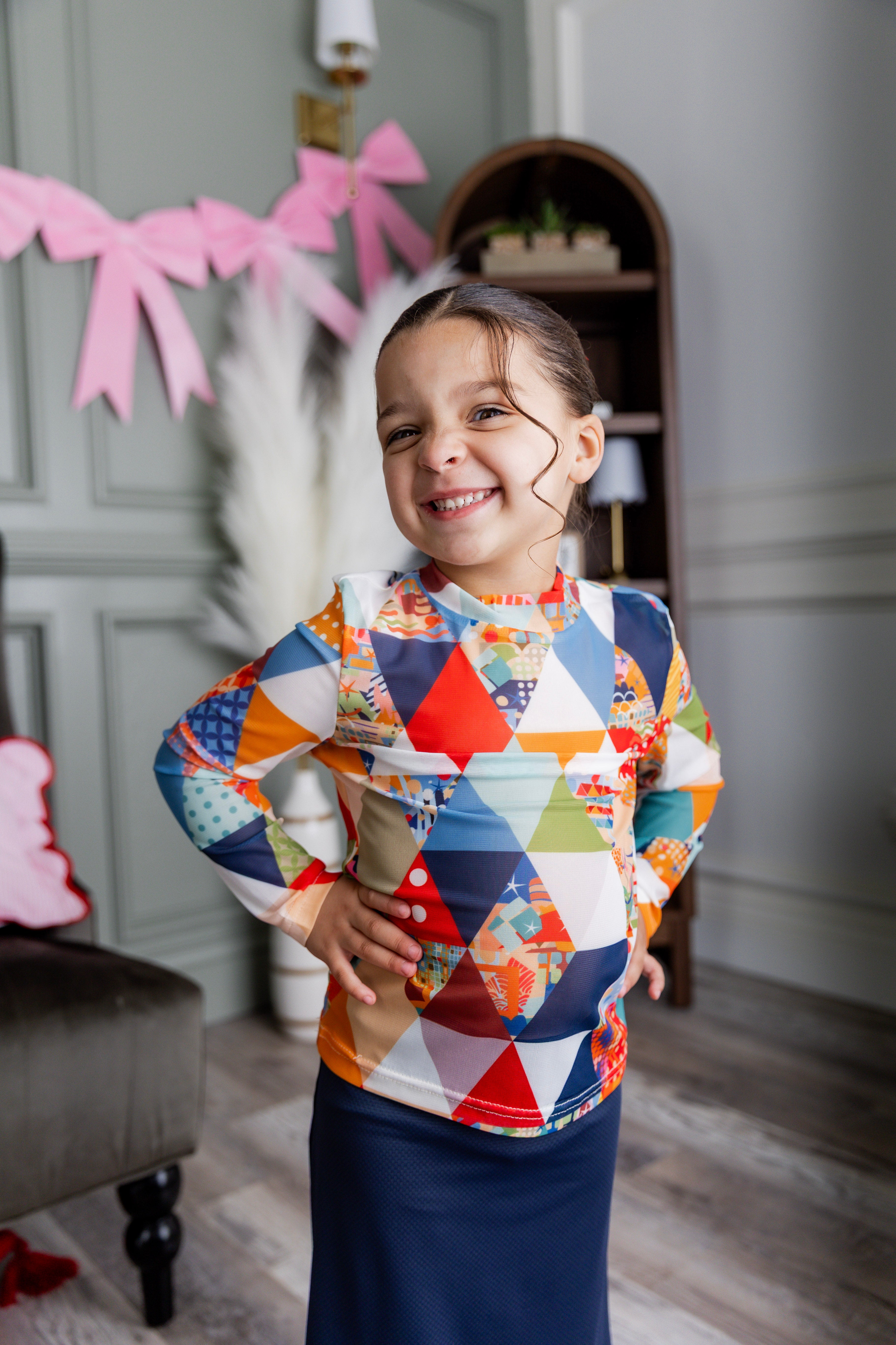 Model wearing Nuggles® Girls' Mesh Tee in Triangle Taffy