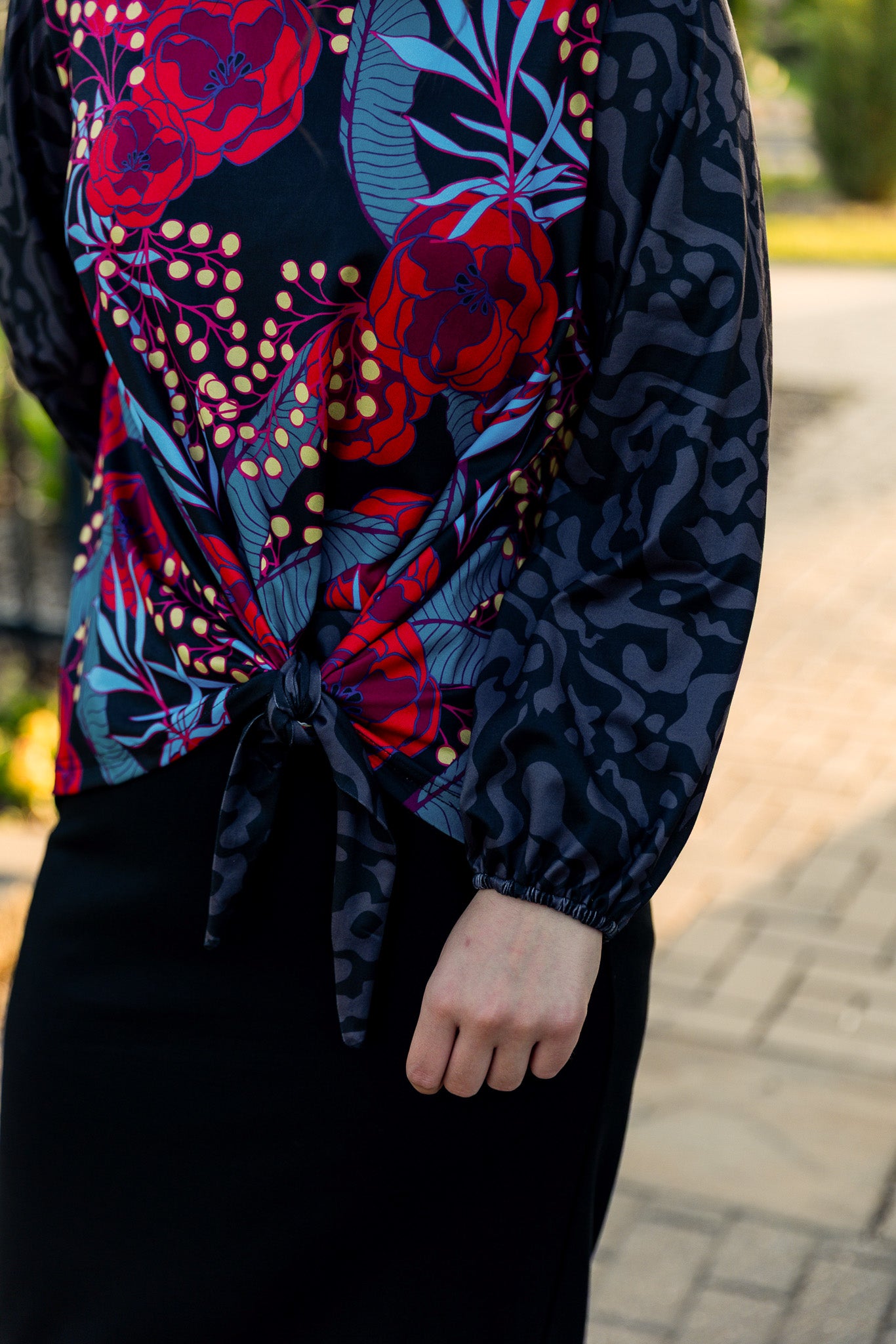 modest long sleeve top with a tie knot and contrasting knit fabrics