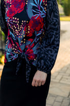 modest long sleeve top with a tie knot and contrasting knit fabrics