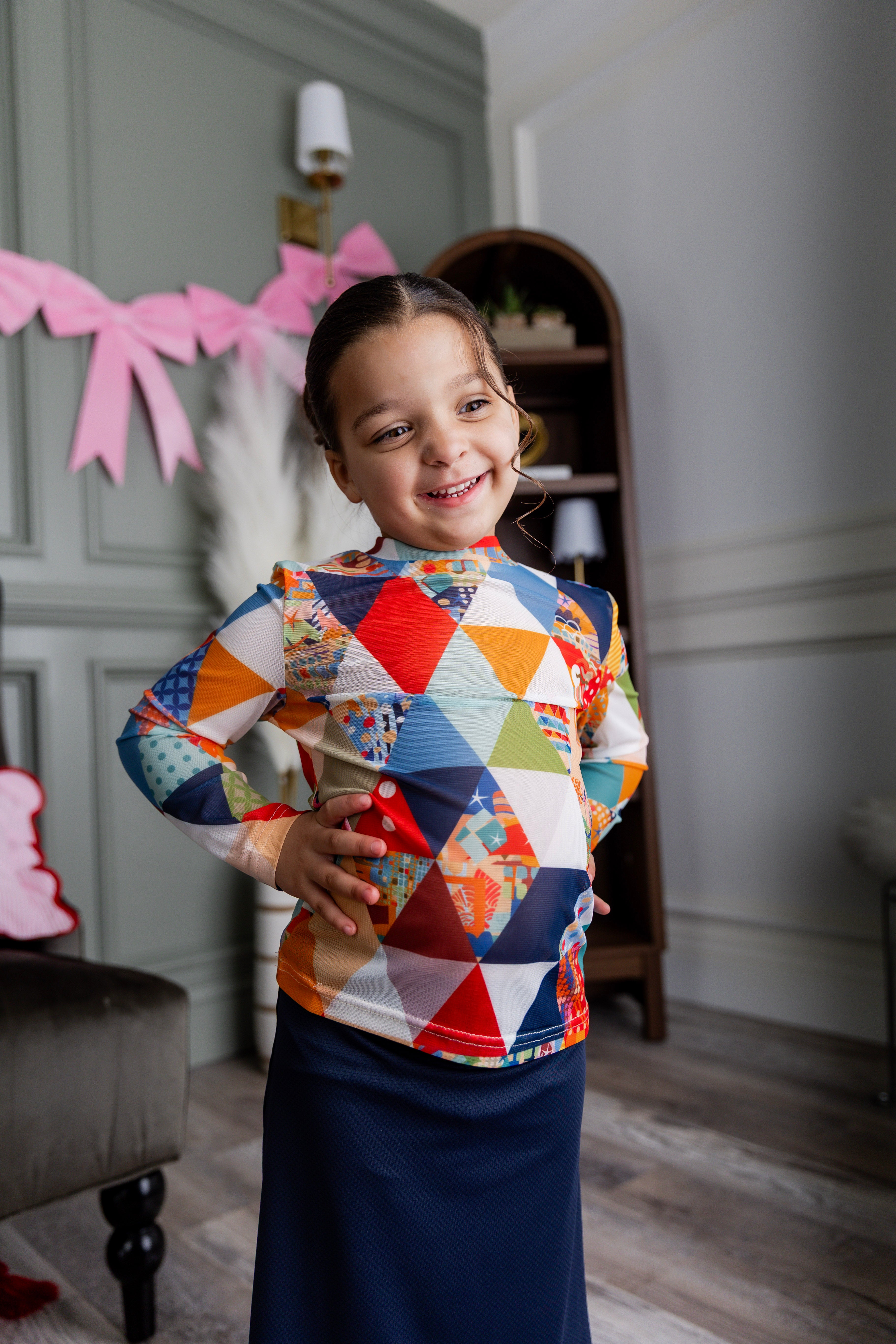 Model wearing Nuggles® Girls' Mesh Tee in Triangle Taffy