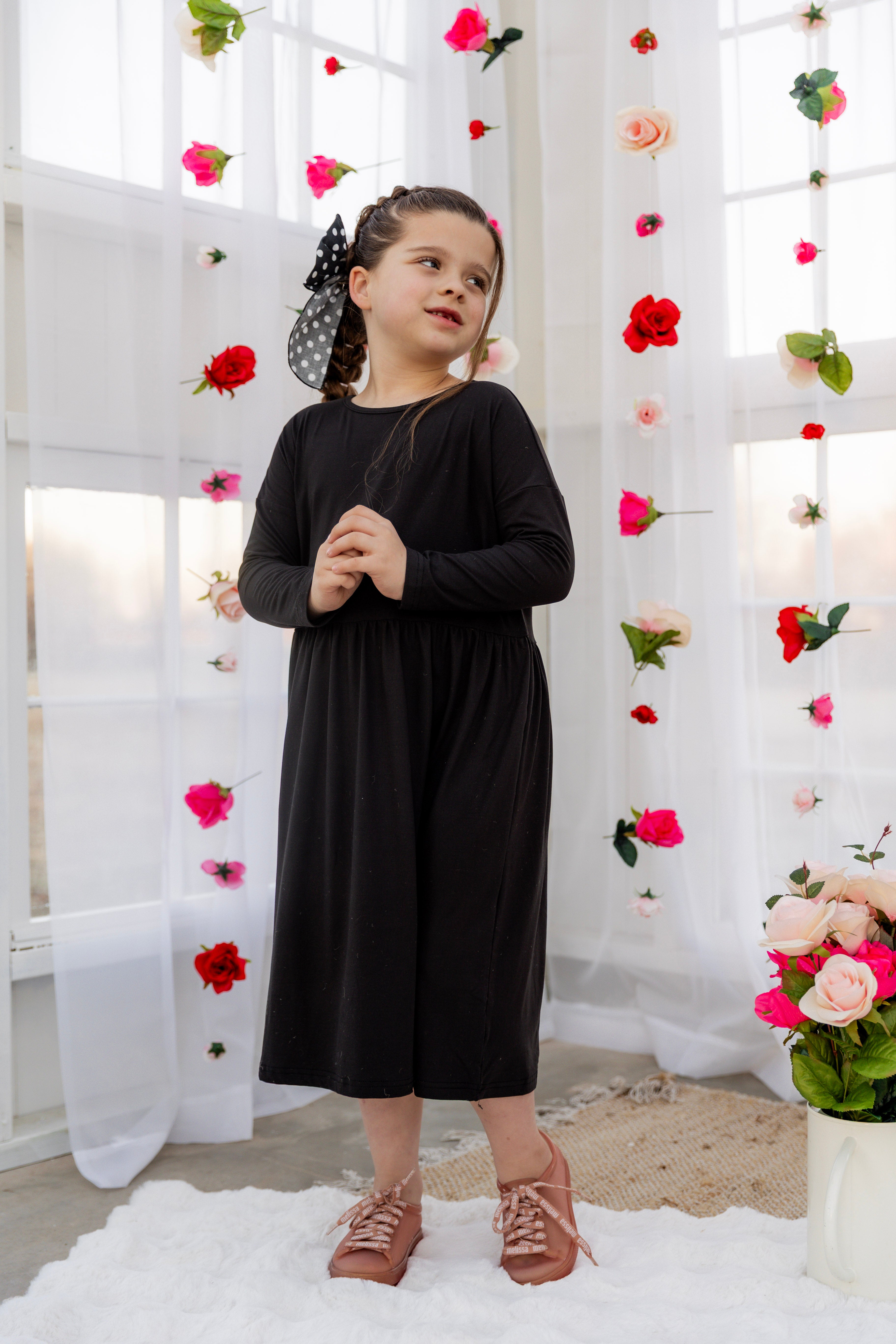 Model wearing the Nuggles® Girls' Farah Dress in Black