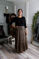 Model wearing the Nuggles® Sage Skirt in leopard print, designed with a flowy tiered hem and comfortable elastic waistband.