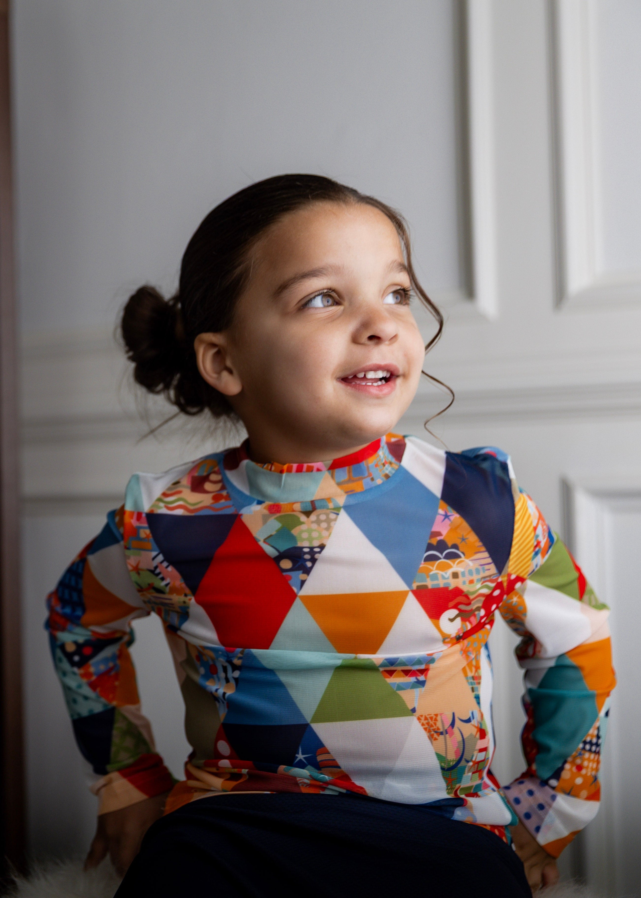 Model wearing Nuggles® Girls' Mesh Tee in Triangle Taffy