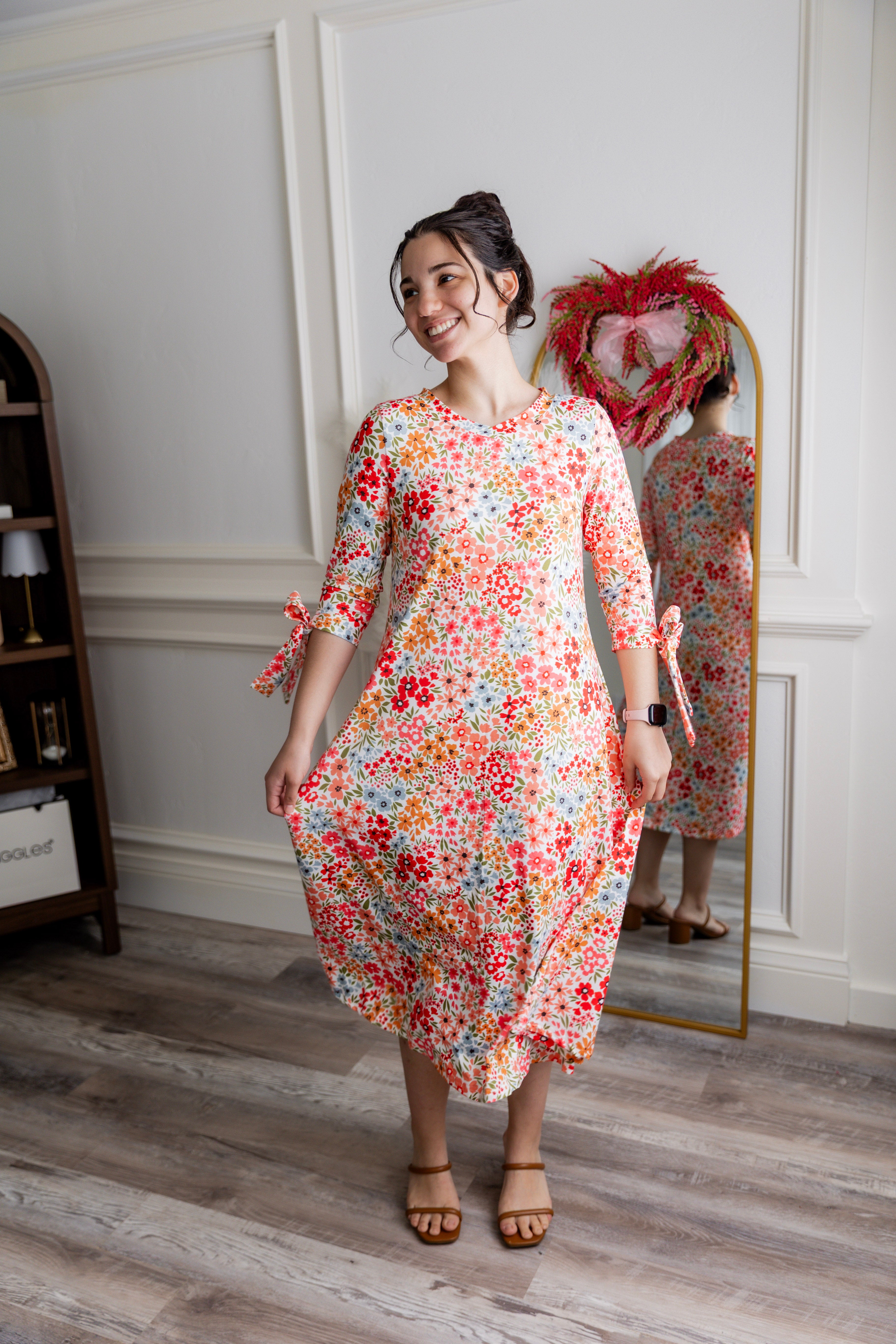 Model wearing the Nuggles® Hazel Dress in Confetti Garden Bloom floral print modest boutique dress
