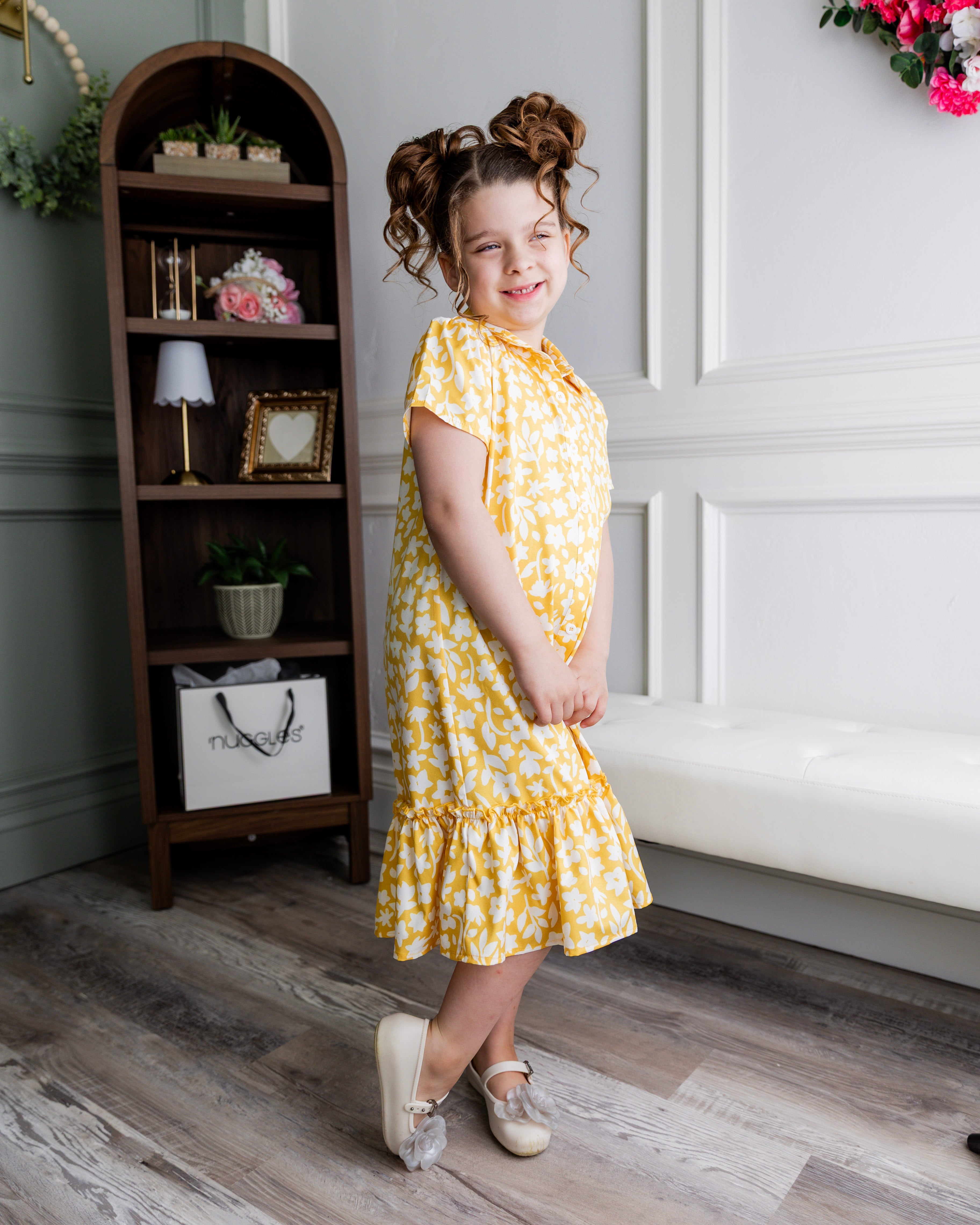 Model wearing Nuggles® Girls' Ellie Dress Dress in Sunshine Sprigs
