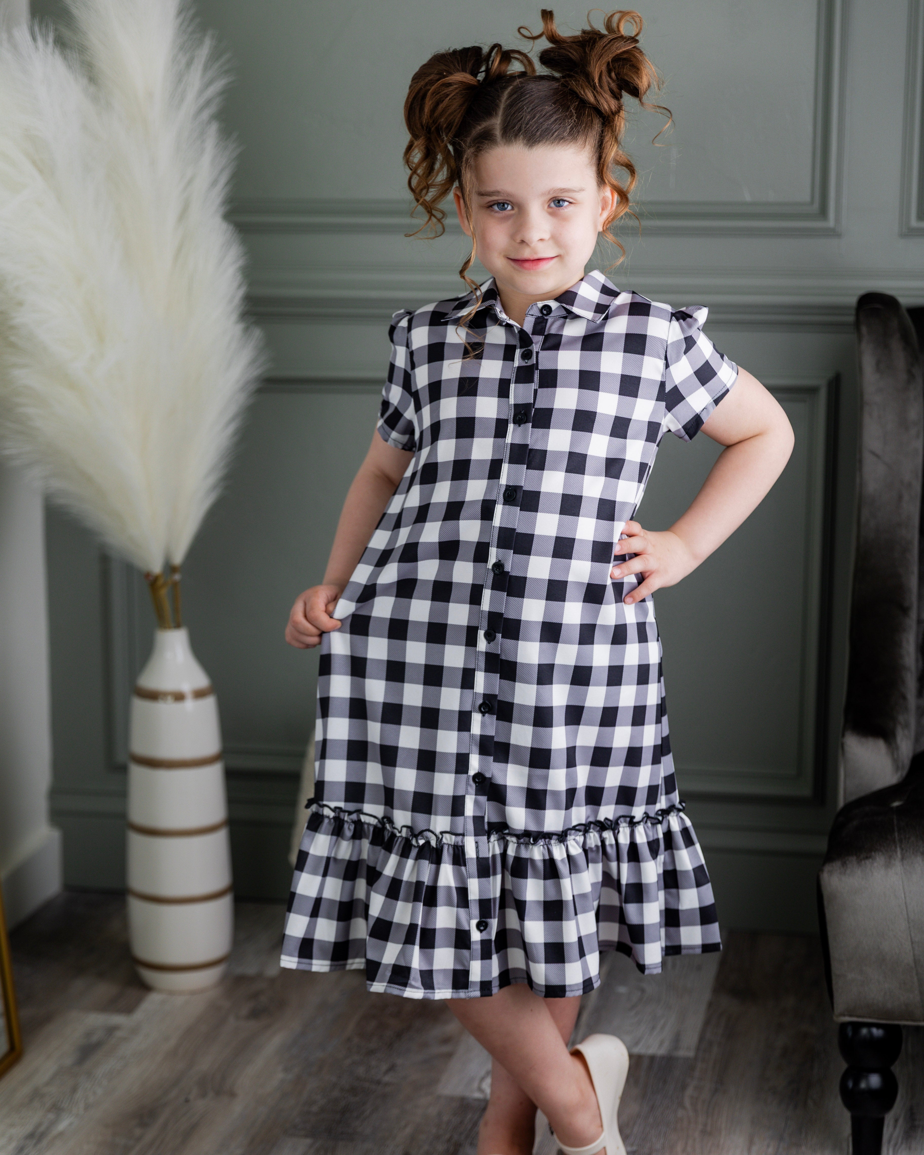 Model wearing Nuggles® Girls' Ellie Dress Dress in Storybook Check