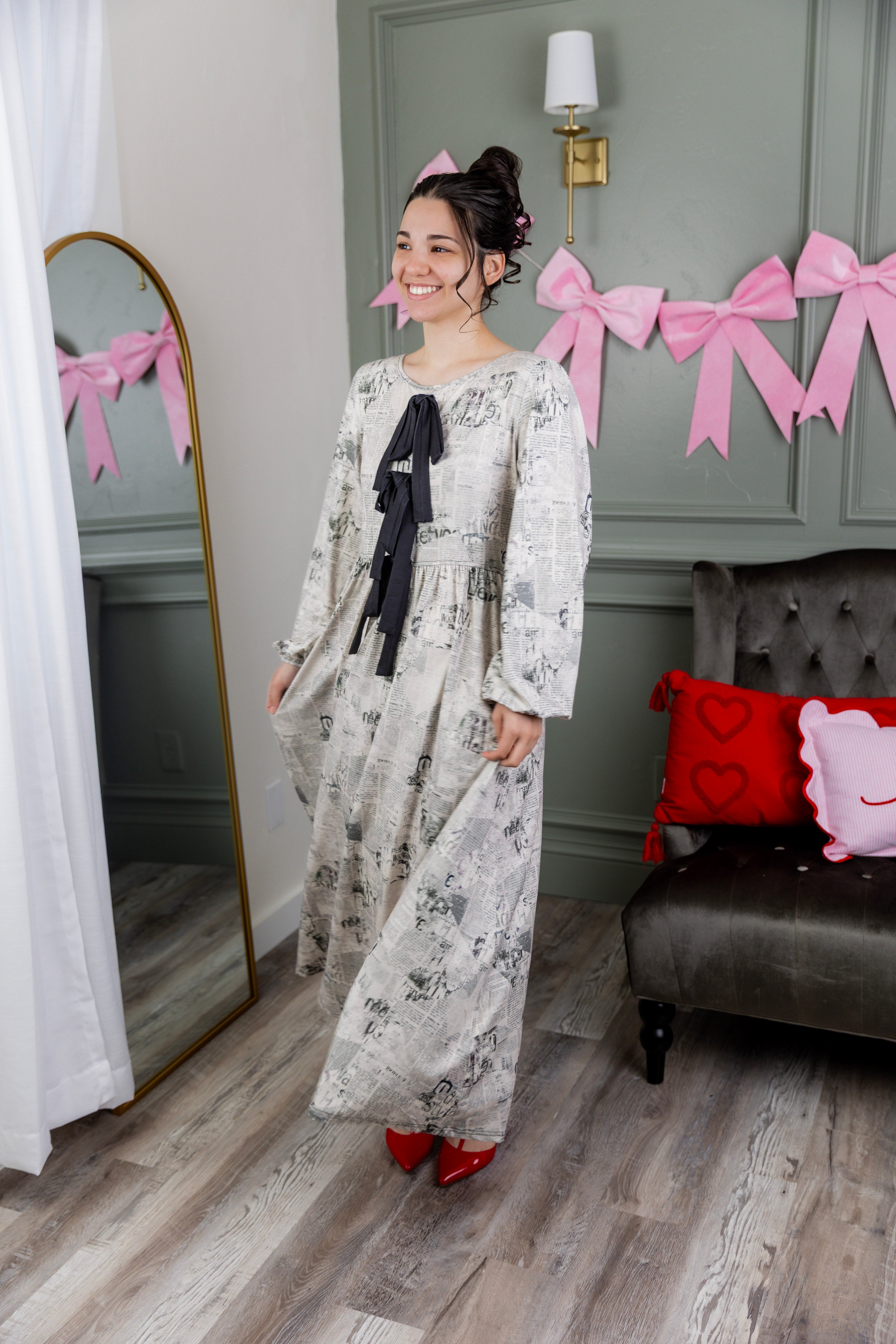 Model wearing the Nuggles® Addison Dress in Whispering Headlines