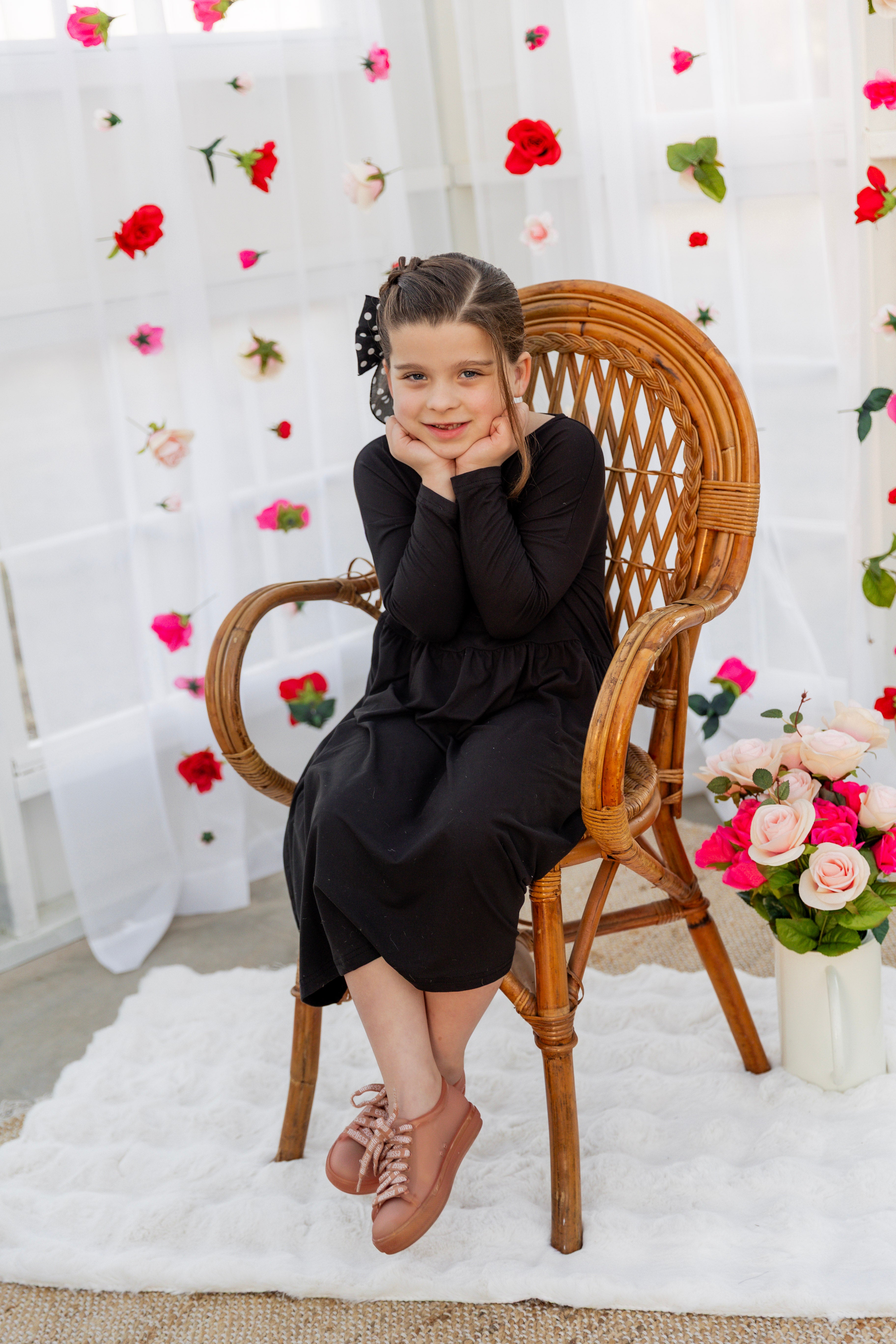 Model wearing the Nuggles® Girls' Farah Dress in Black