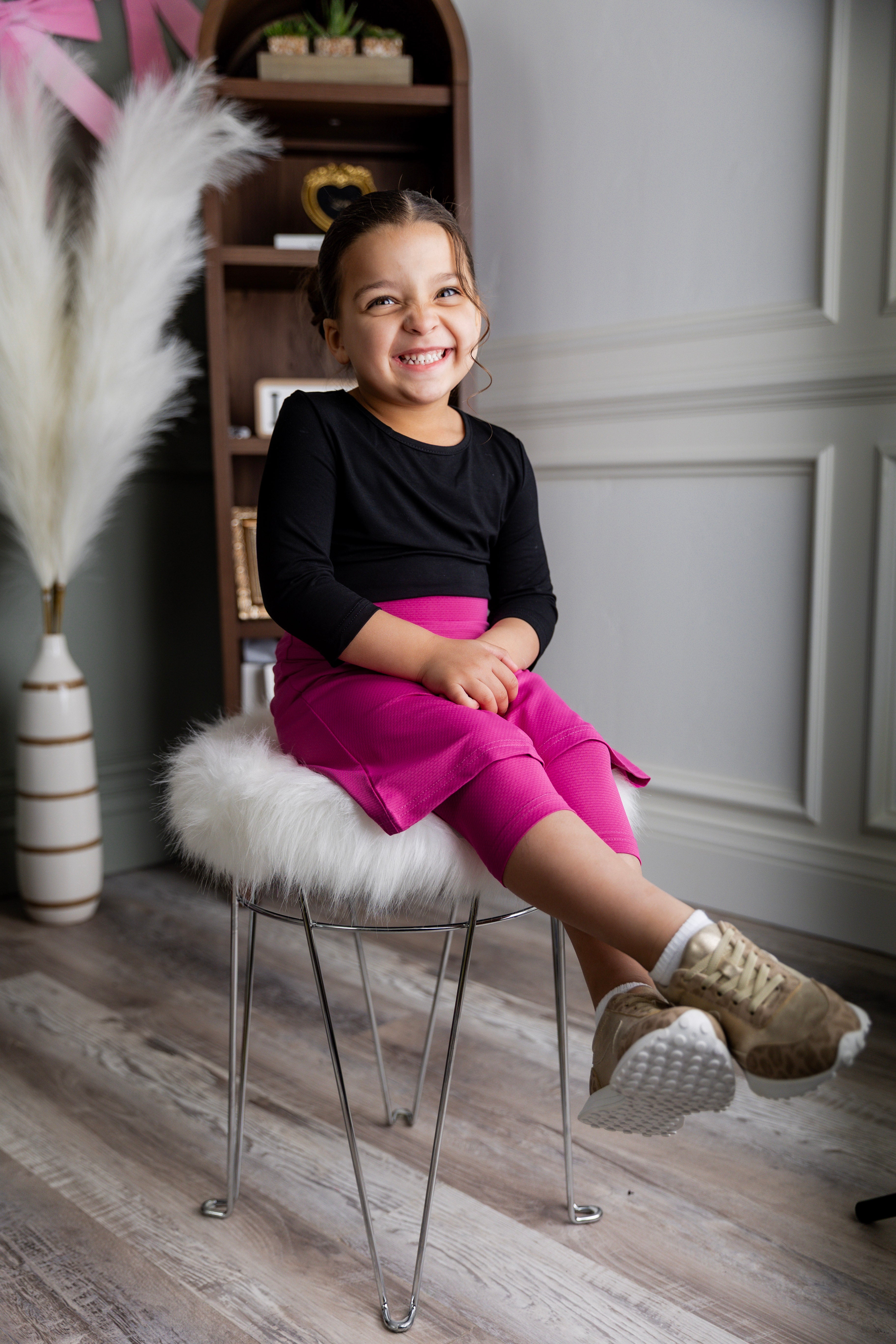 Model wearing Nuggles® Girls' All-Sport Skirt in Hot Pink