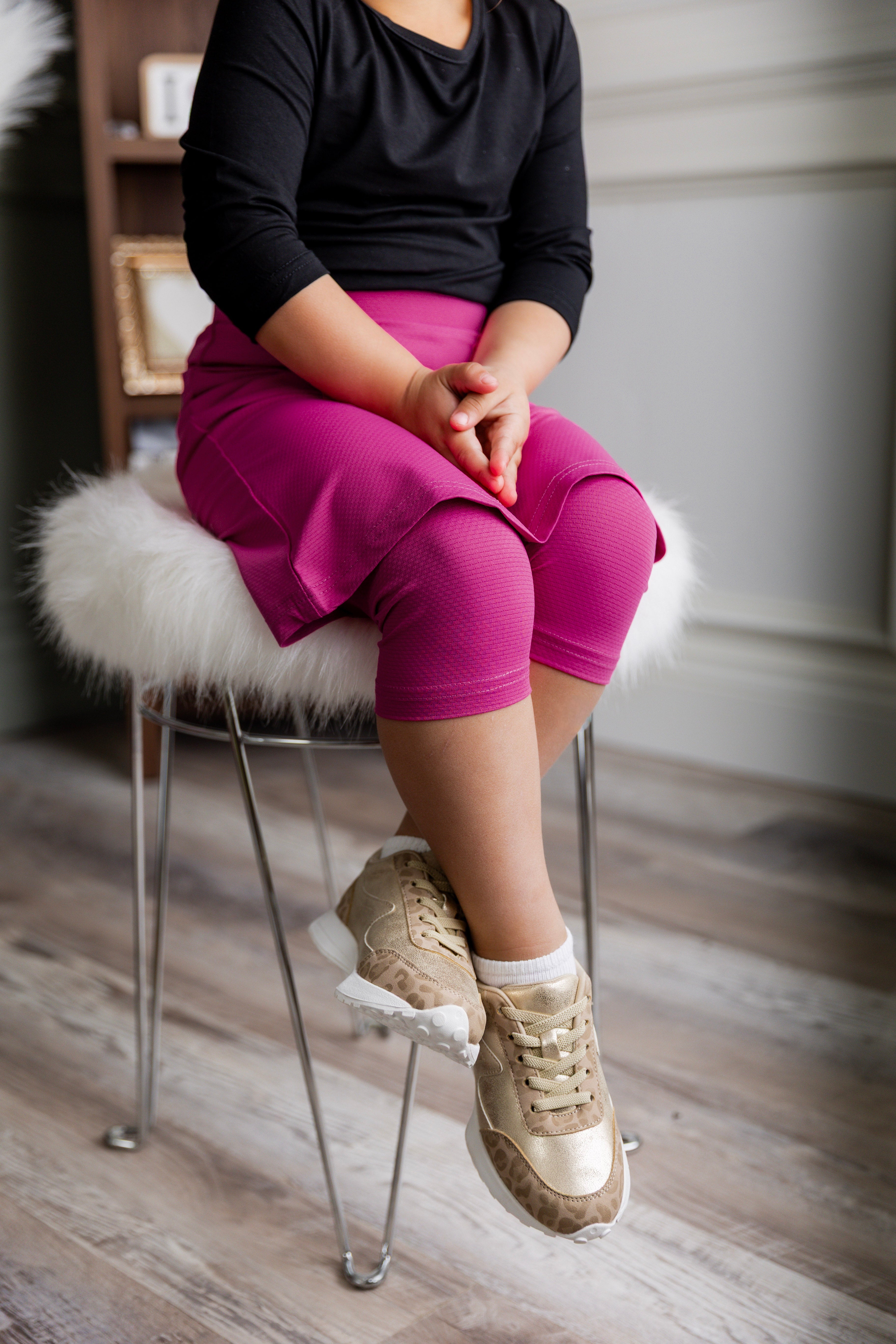 Model wearing Nuggles® Girls' All-Sport Skirt in Hot Pink