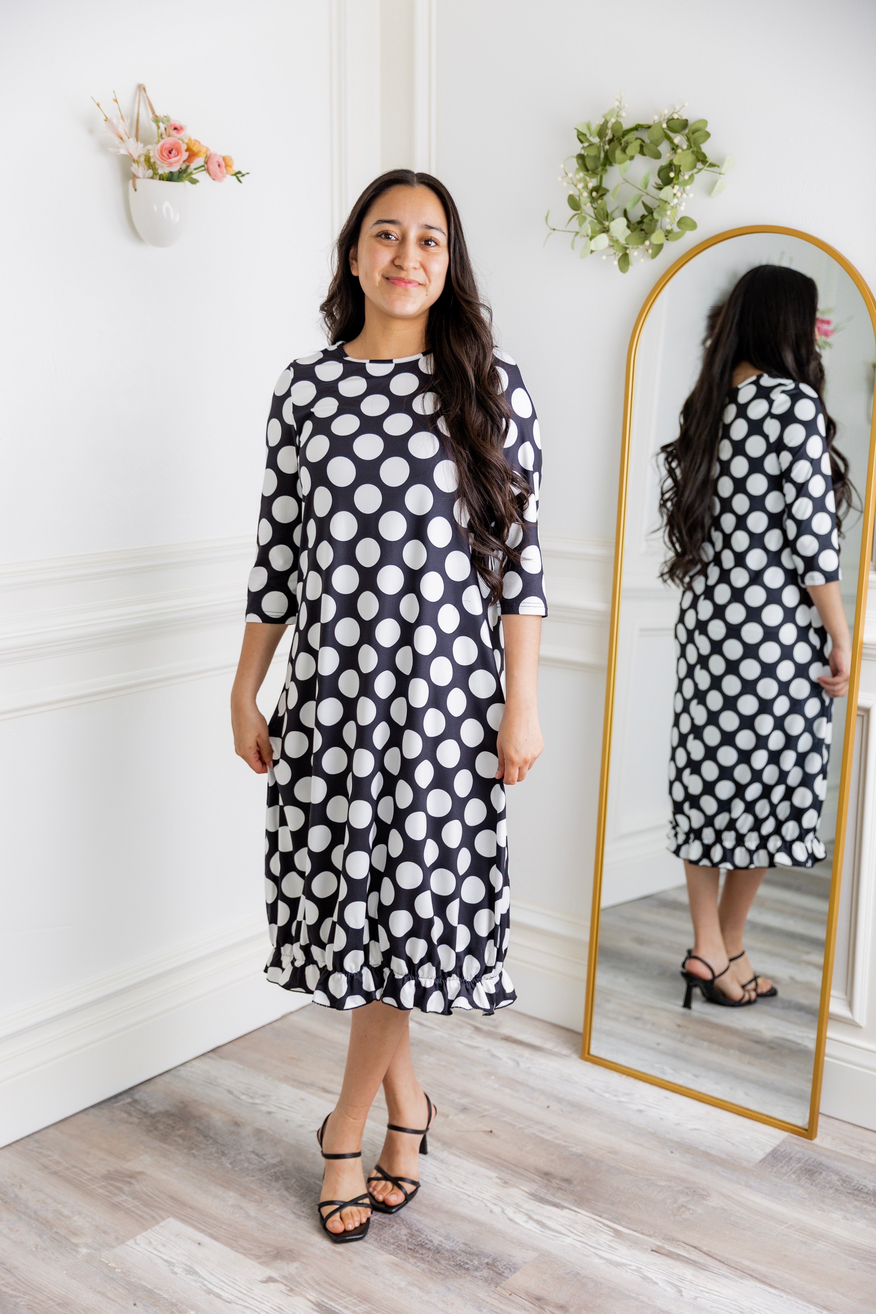 Model wearing our Nuggles® modest Bristol midi dress with 3/4 sleeves and elastic ruffle hem in various prints.