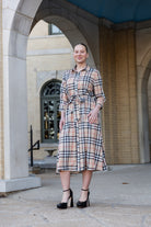 Model wearing the Nuggles® Rachel Dress in Sand Plaid
